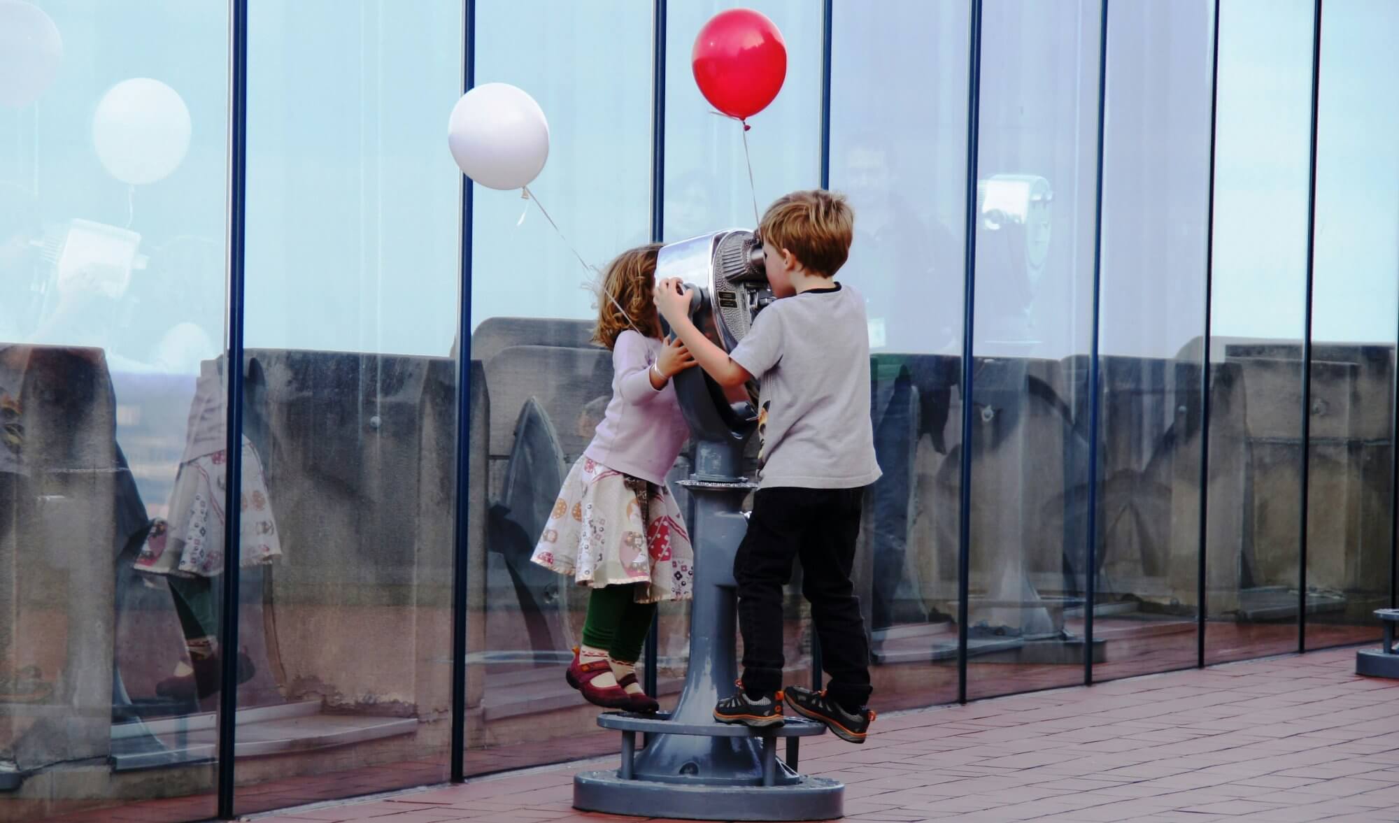 Children looking through a telescope, symbolizing destiny, curiosity, and the possibilities ahead.